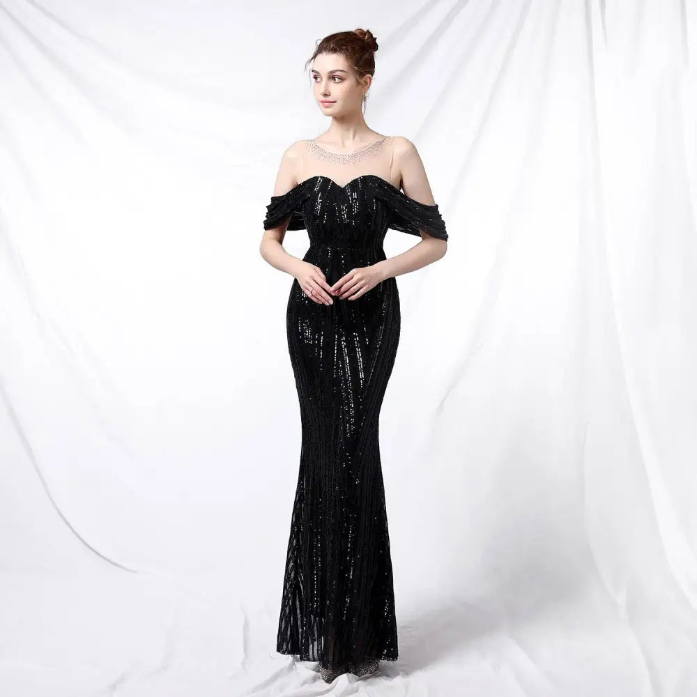 Black sequined off-the-shoulder mermaid gown with ruffled sleeves and fitted silhouette for elegant occasions