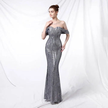 Silver off-the-shoulder sequined mermaid gown with fitted bodice and flowing skirt in shimmering silver fabric