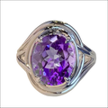 Silver oval amethyst ring with a large purple stone and an intricate braided silver band, perfect as a fashion amethyst ring