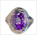 Silver oval amethyst ring with braided band featuring a prominent oval-cut amethyst in a fashion amethyst ring design