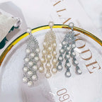 Three silver pearl micro inlay zircon style beaded fringe earrings with cascading imitation pearls and gold-tone centers