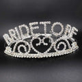 A sparkling silver rhinestone bridal headband featuring intricate scrollwork and bold queen lettering for luxury women’s fashion