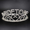 A sparkling silver rhinestone bridal headband featuring the word queen and intricate swirling patterns for luxury women’s fashion