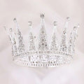 A sparkling silver retro round bridal crown with clear crystals and intricate lace-like metalwork in silver alloy