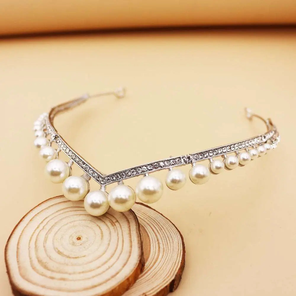 A delicate silver wedding crown alloy tiara with sparkling rhinestones and lustrous white pearls