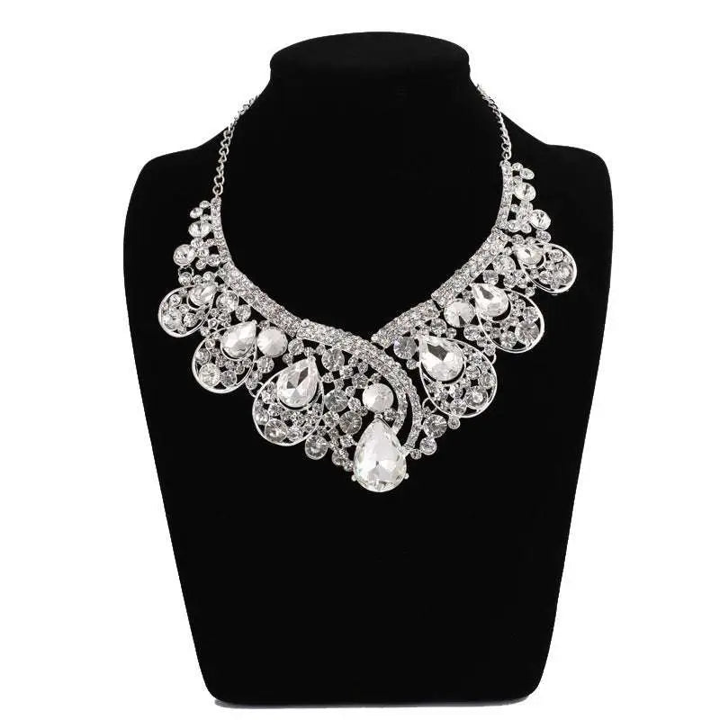 A silver rhinestone korean super alloy jewelry set featuring a sparkling statement necklace with filigree and teardrop crystals