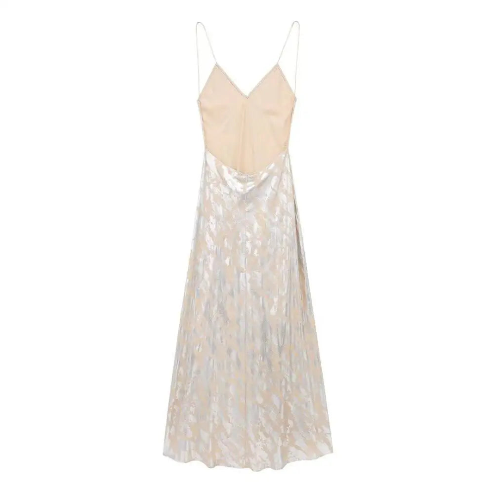 A flowing floor-length printed underwear dress with a beige satin bodice and shimmering silver metal foil printed lace skirt