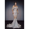 A shimmering silver sequin mermaid female singer gown with off-the-shoulder sleeves and flowing train for nightclub DJ female use