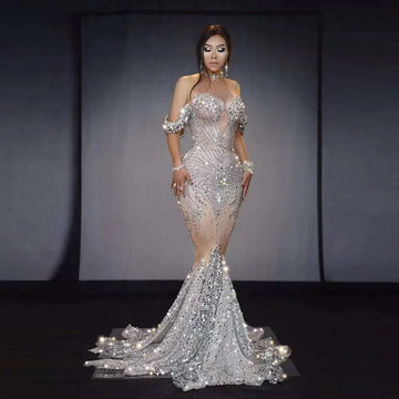 A shimmering silver female singer gown with intricate beading, off the shoulder sleeves, perfect for nightclub dj female use