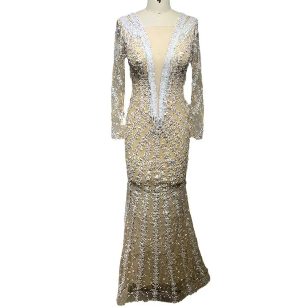 Silver sequined backless tight fishtail gown with long sheer sleeves and a plunging v-neckline in shimmering fabric