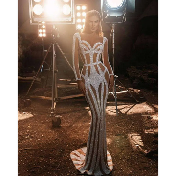 Silver sequined form-fitting banquet evening dress with geometric cutouts for a sprinkled gold banquet event