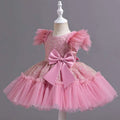 Pink sequined toddler dress with tulle puff sleeves and satin bow in a silver sequined wedding dress tulle style