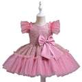 Pink sequined toddler dress with ruffled tulle skirt and matching satin bow for a sequined wedding dress tulle look