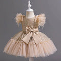 A shimmering gold sequined wedding dress tulle skirt with fluffy feathered sleeves and beige satin bow at the waist