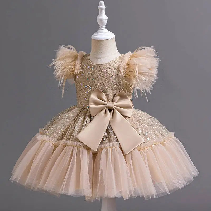 A shimmering gold sequined wedding dress tulle skirt with fluffy feathered sleeves and beige satin bow at the waist