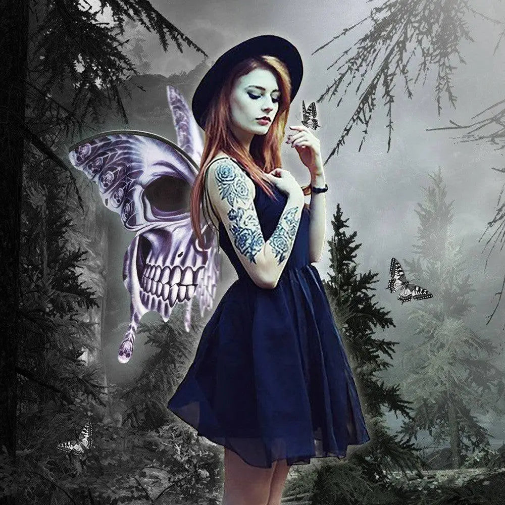 A woman wearing silver skull halloween butterfly wings with white skull-patterned butterfly wings flowing holds a small butterfly