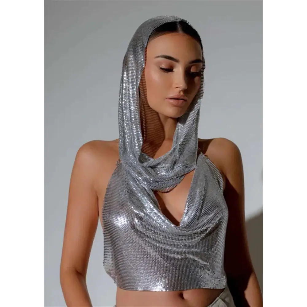 Silver mesh hooded crop top with cowl neckline featuring reflective slit metal sequins and chain-like texture