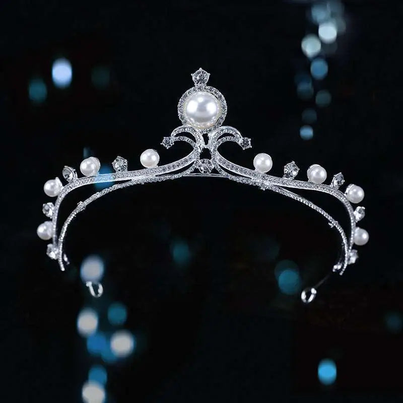 Elegant silver bridal crown adorned with sparkling diamonds and lustrous baroque pearls for bridal wear