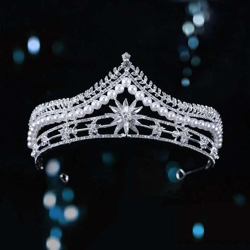 Silver bridal crown baroque pearl tiara with intricate crystal detailing and a central starburst motif