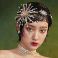Silver starburst bridal rhinestone headband with crystals gold accents and a central pink gemstone for brides