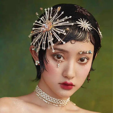 Silver starburst bridal rhinestone headband with crystals gold accents and a central pink gemstone for brides