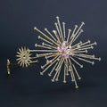 Gold-toned starburst bridal rhinestone brooch with clear crystals and central pink gemstone flower for bridal rhinestone headband