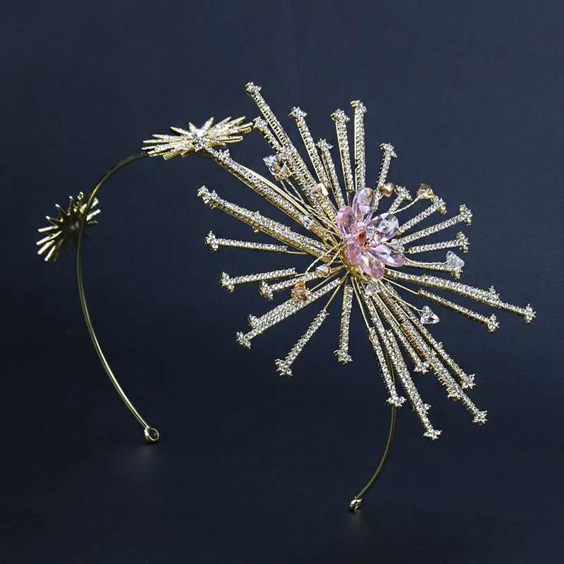 Delicate gold-toned bridal rhinestone headband with starburst design featuring clear crystals and central pink gemstone flower