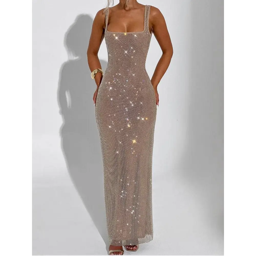 A shimmering champagne strap sequins net drill suspenders gown with thin straps and a square neckline