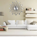 Silver sunburst mute wall clock with sparkling crystal accents and black metal rays for living room decor