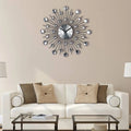 Silver sunburst mute wall clock with black metal rays and sparkling crystal accents for living room decor