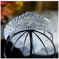 A silver super flash zircon crown tiara with sparkling clear and light blue crystals in an elegant arched design