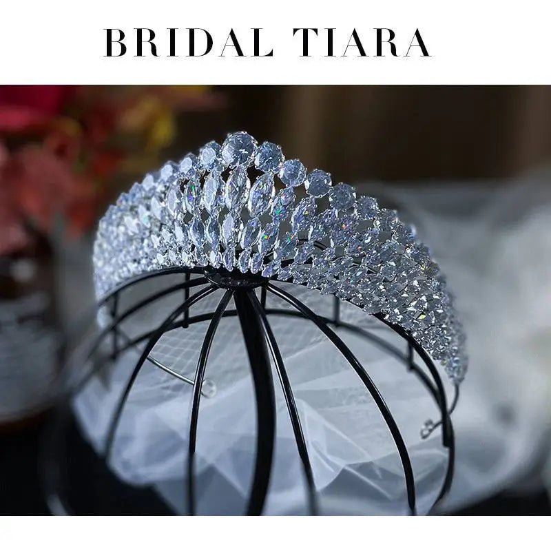 A silver super flash zircon crown tiara featuring a woven metal design with clear faceted crystals sparkling brightly