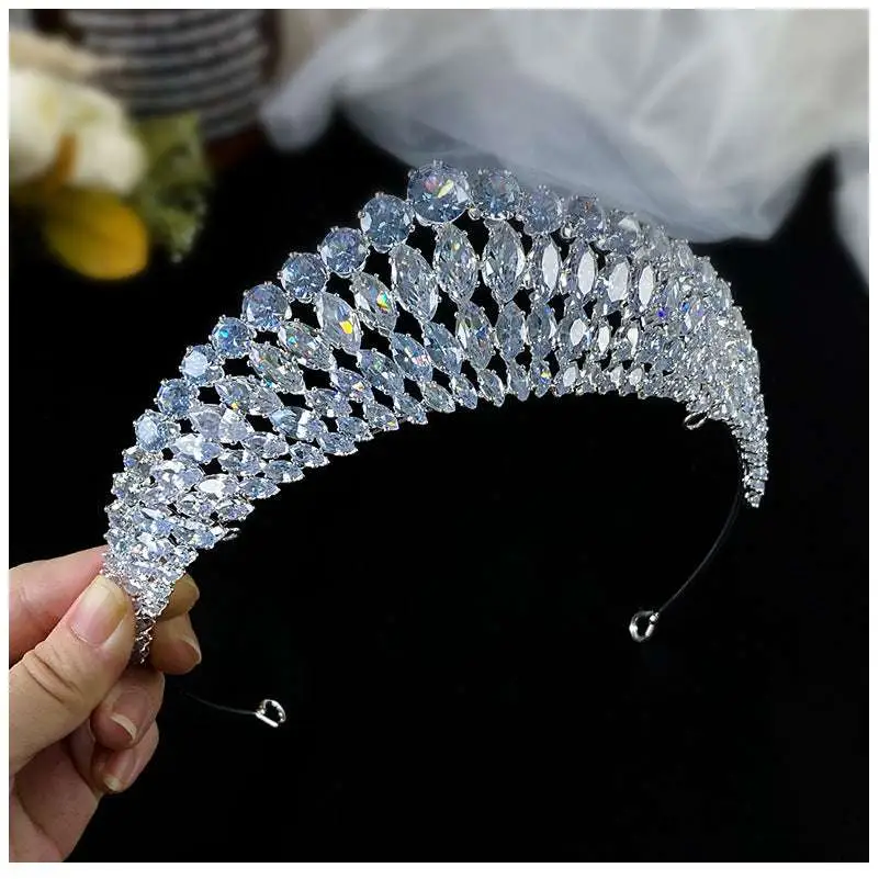 A silver super flash zircon crown tiara featuring a sparkling silver tiara with clear faceted crystals in cascading pattern