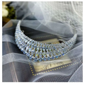 A silver super flash zircon crown tiara featuring cascading rows of clear and light blue crystals in a sparkling design