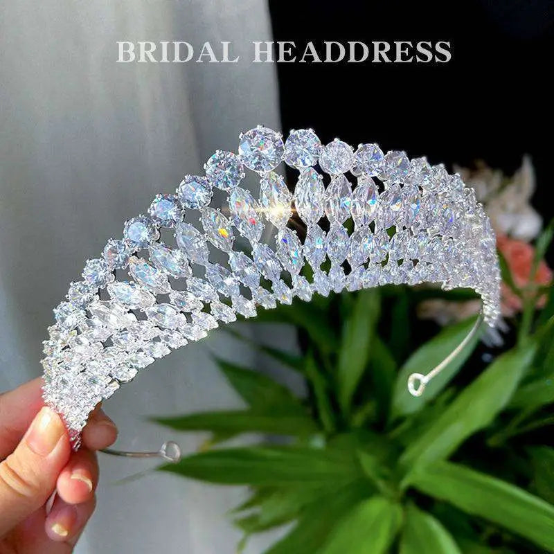 A silver super flash zircon crown tiara featuring numerous clear faceted crystals in an elegant arch design