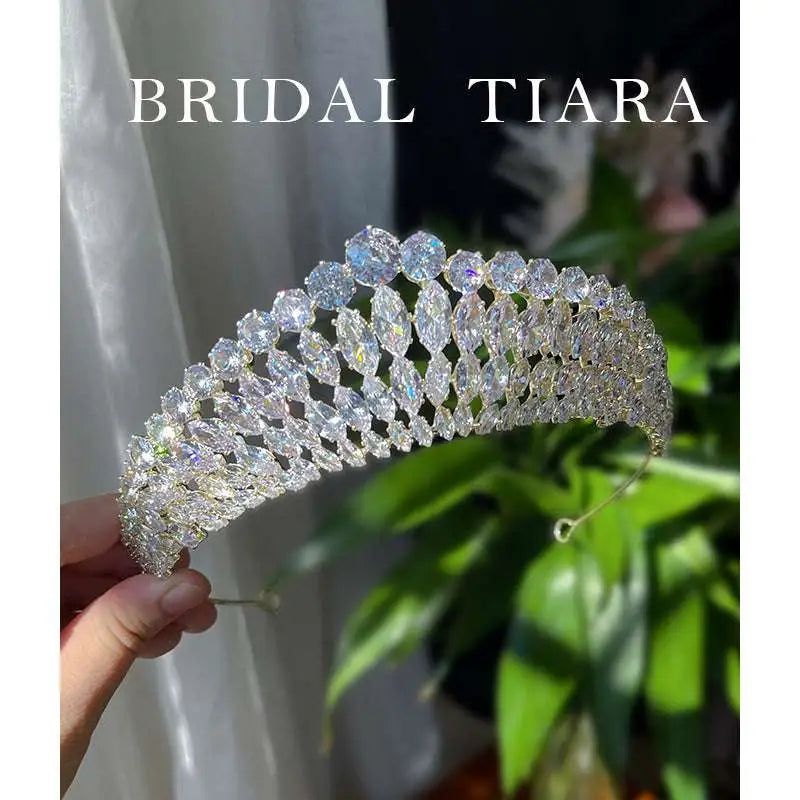 A sparkling gold bridal zircon crown tiara with a cascading array of clear super flash zircon crystals