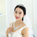 A silver tiara with intricate lace detailing and american rhinestone claw chain features sparkling rhinestones