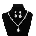 Silver v-shaped crystal bridal jewelry set featuring a sparkling silver crystal necklace with matching teardrop earrings