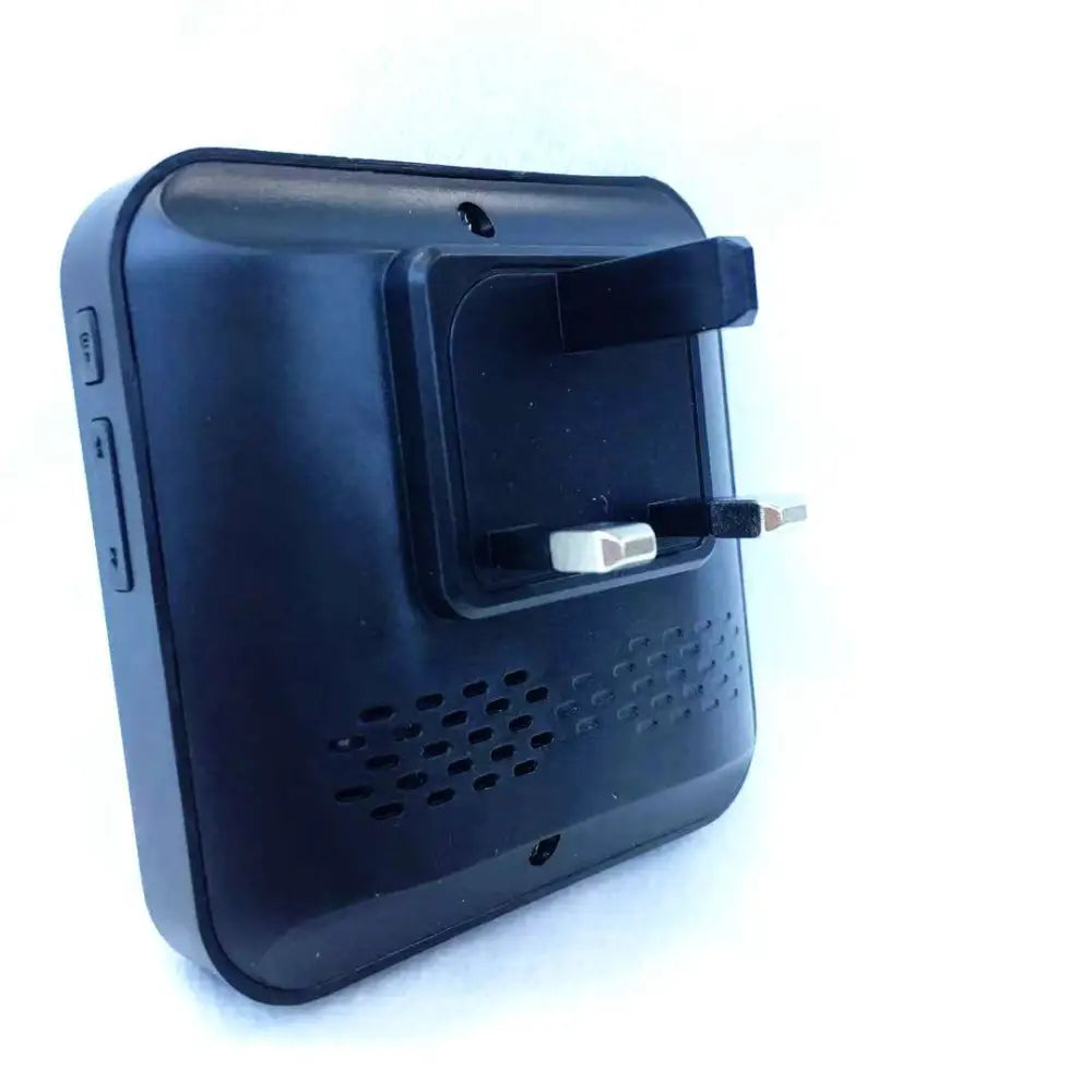 Black plastic wall-mounted video doorbell smart wireless device with uk-style plug and perforated speaker grille shown from back side