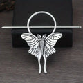 Silver-toned female viking barrette shaped like a moth with detailed wing patterns and a circular top in alloy material