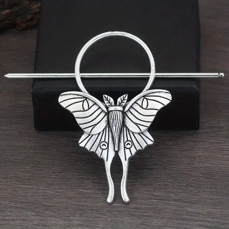 Silver-toned female viking barrette shaped like a moth with detailed wing patterns and a circular top in alloy material
