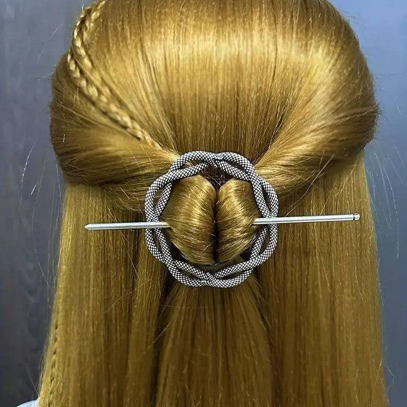 Silver-toned female viking barrettes featuring a woven black and white patterned circular hairpin design made of alloy