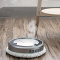 Silver white intelligent automatic sweeping robot with a soft fluffy cleaning pad and blue microfiber cleaning surface