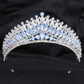 A silver crystal bridal crown featuring white leafy opal and cascading light blue and clear crystals for brides