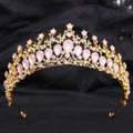 A delicate gold crystal bridal crown featuring pink teardrop stones and white leafy opal crystals for brides