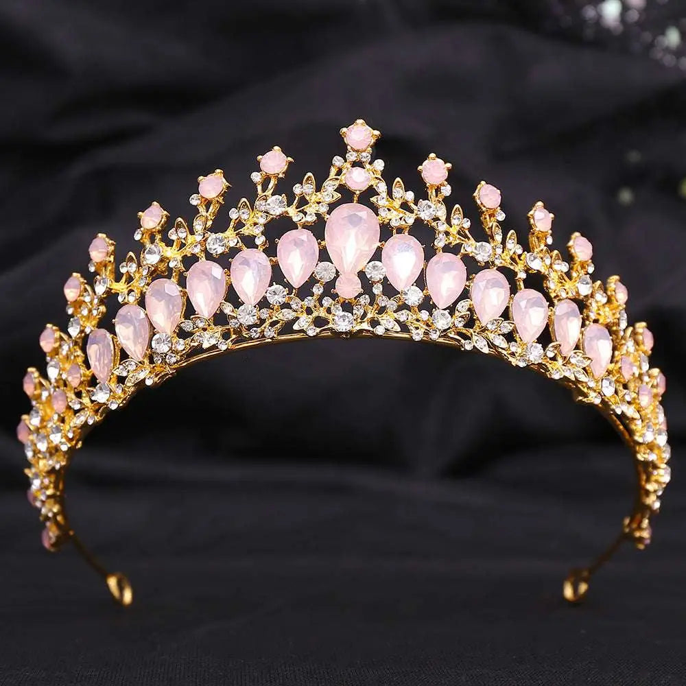 A delicate gold crystal bridal crown featuring pink teardrop stones and white leafy opal crystals for brides