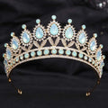 Delicate gold-toned crystal bridal crown featuring white leafy opal and clear crystals in an elegant bridal design