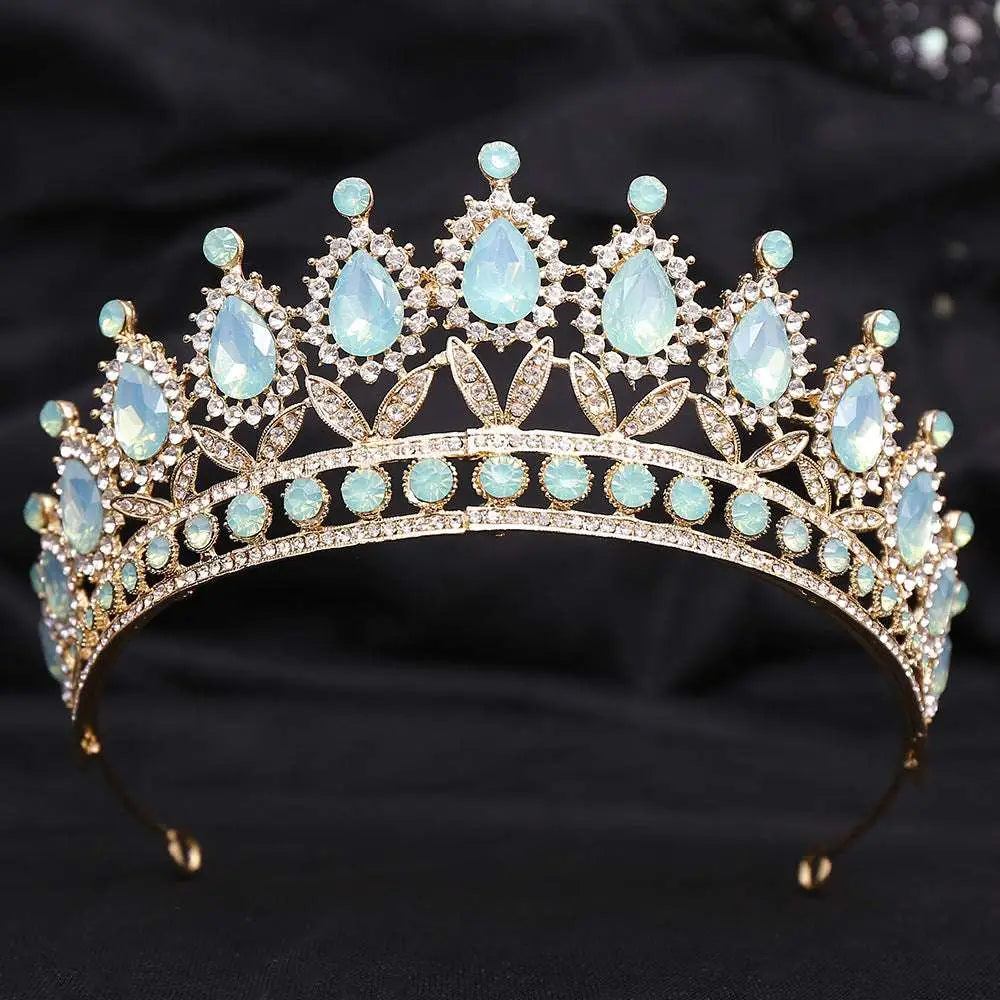 Delicate gold-toned crystal bridal crown featuring white leafy opal and clear crystals in an elegant bridal design