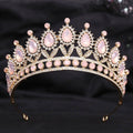 A gold-toned crystal bridal crown featuring pink rose quartz teardrop stones and a white leafy opal motif design
