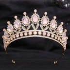 A gold-toned crystal bridal crown featuring pink rose quartz teardrop stones and a white leafy opal motif design